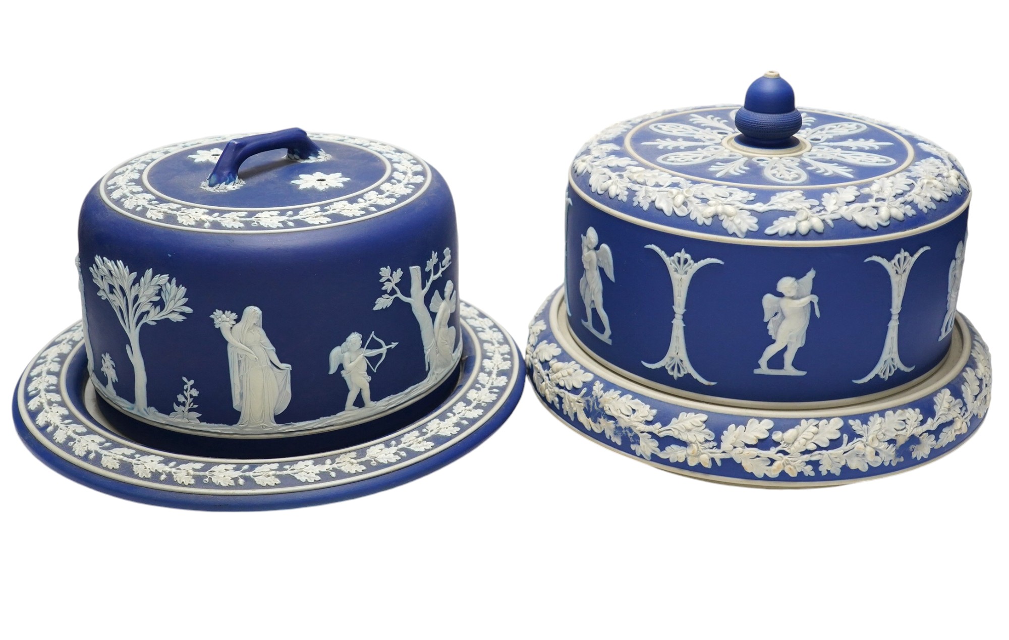 Two Wedgwood blue jasperware cheese dishes and covers, largest 29cm in diameter. Condition - good